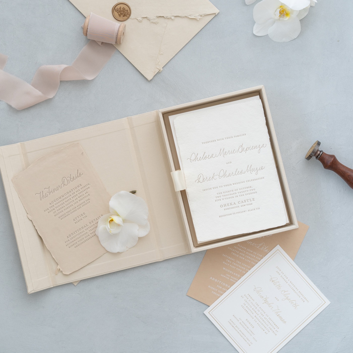 Ivory invitation box shown with loose stationery
